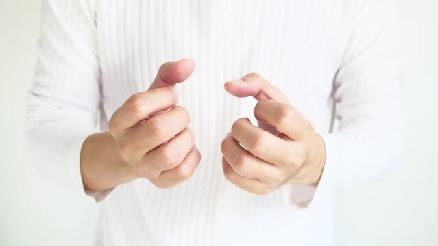 Man moves his fingers and wrists He exercises on his wrists and fingers. He has numbness in his hands and fingers from a tendon injury in the palm of his hand.