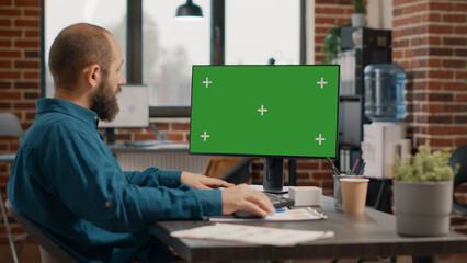 Entrepreneur working with green screen on computer to plan business project. Employee using chroma key with isolated template and mockup background on monitor, designing strategy. - Powered by Adobe