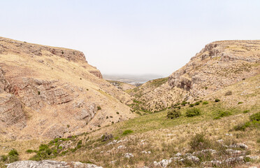 Overgrown  with grass and bushes, the slope of Mount Arbel, located on the shores of Lake Kinneret - the Sea of Galilee, near the city of Tiberias, in northern Israel.