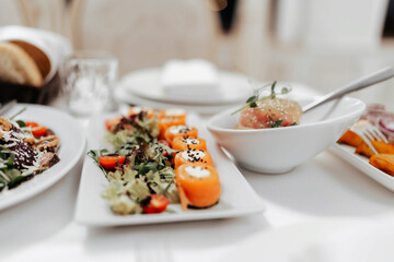 Appetizer. Cold table. dish of red fish on the table with salads and greens