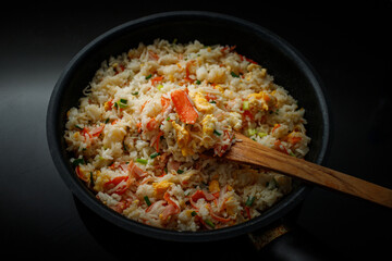 Fried rice with crab sticks in a pan for home cooking