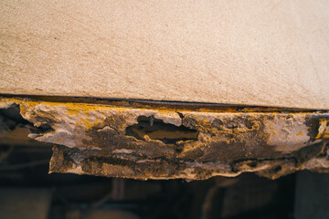 Rusted white car sills close-up. The effect of reagents in winter on an unprotected car body