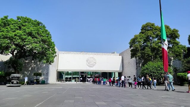 timelapse of a long line of passers-by waiting to enter the national museum of anthropology in mexico city