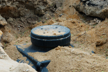 A cable underground well is installed in a pit and sprinkled with sand. New environmentally...