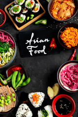 Assortment of Korean food on dark background.