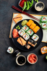 Fototapeta na wymiar Sushi assortment on dark background.