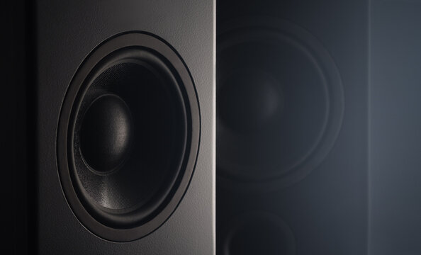 Stereo sound speakers closeup on black background with copy space. Contrast, accent lighting from the side