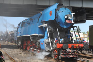 Antique powerful blue steam locomotive type ČSD Class 477.0 from Czech bursting steam and vapour...