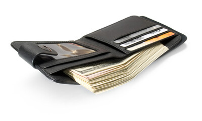 Black leather wallet with dollars and plastic cards isolated on white background.