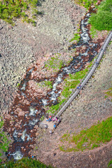Platform with tourists on a hiking trail along a river