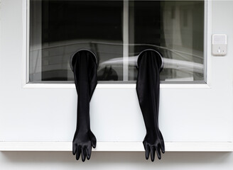 Mobile swab test with black rubber gloves in windows