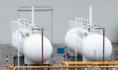 Two white fuel oil tanks are used for industrial plants.