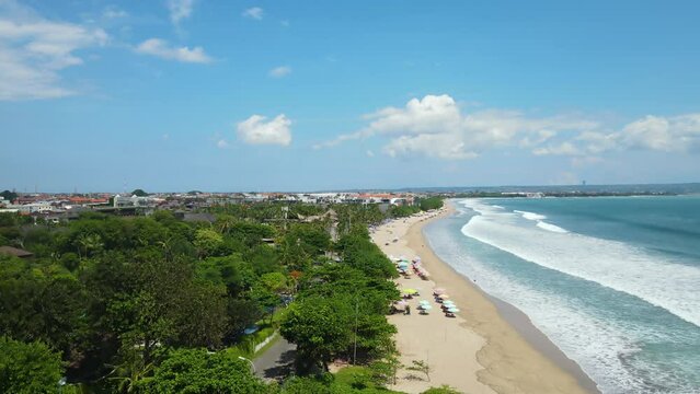 Aerial View of Legian Beach, Kuta, Bali Island, Indonesia. Sandy Shore, Ocean Waves and Tropical Lush, Drone Shot