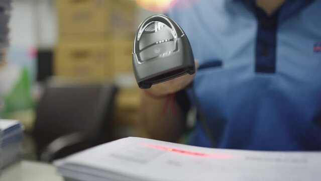 Close-up, Hand of woman using barcode reader scan barcode for convert data into digital computer.
