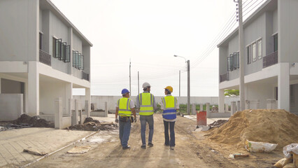 A group of workers, a designer team talk, communicate, discuss, and working on industrial construction site at home architecture building project. People lifestyle.