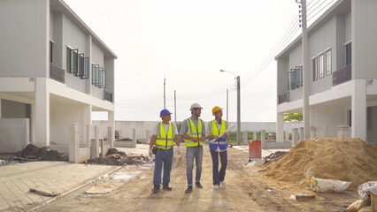 A group of workers, a designer team talk, communicate, discuss, and working on industrial construction site at home architecture building project. People lifestyle.