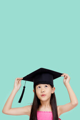 Happy Asian school girl with copy space. Student child graduate in graduation cap.