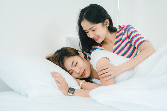 lgbtq, lgbt concept, homosexuality, portrait of two Asian women posing happy together and showing love for each other while being together at bedroom