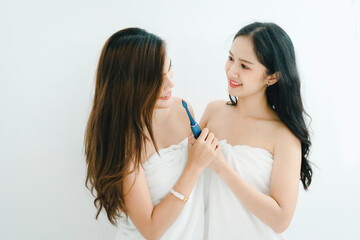 lgbtq, lgbt concept, homosexuality, portrait of two asian women posing happy together and showing love for each other while brushing teeth