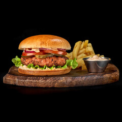 Close up view of Fresh tasty beef burger and french fries on wooden tray