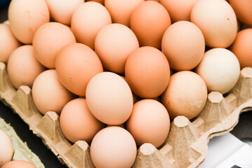 Eggs lying on top of each other in a supermarket for sale.