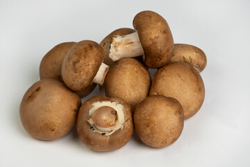 Raw portabella mushrooms on a white background