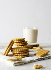 Crispy shortbread cookies with cream filling on a light napkin