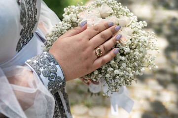Fototapeta premium wedding rings on the hands of the young, the creation of a new young family, in Ukrainian embroidered shirts