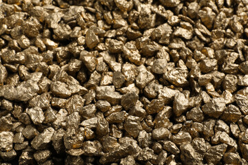 Pile of gold nuggets as background, closeup