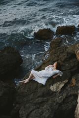 Barefoot woman in white wedding dress on sea shore wet hair nature landscape