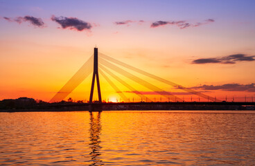picturecque view from water surface to large river and cable - stayed bridge
