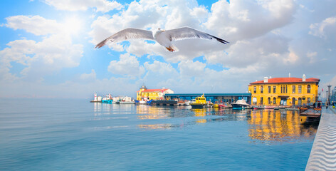 Pasaport pier the most popular destination in izmir with seagull flying over the calm sea - İzmir,...
