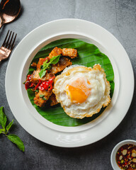 Crispy Pork Basil and Fried Egg,Thai street food concept.Top view
