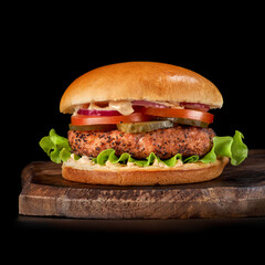 Juicy American burger, hamburger with beef patties, with sauce and basked on a black background. Concept of American fast food.
