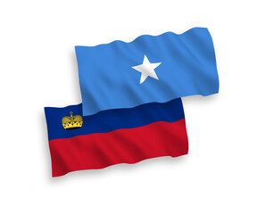 National vector fabric wave flags of Liechtenstein and Somalia isolated on white background. 1 to 2 proportion.