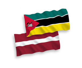 National vector fabric wave flags of Latvia and Republic of Mozambique isolated on white background. 1 to 2 proportion.