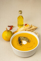 Pumpkin cream soup. Traditional autumn food. Hot dish, ripe vegetables, fragrant spices
