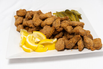 Traditional Viennese chicken Schnitzel on a wooden board.
