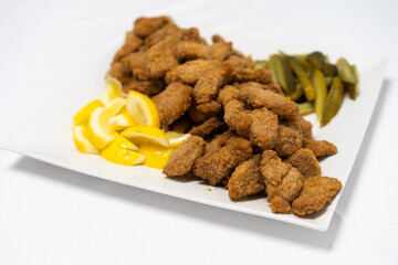 Traditional Viennese chicken Schnitzel on a wooden board.
