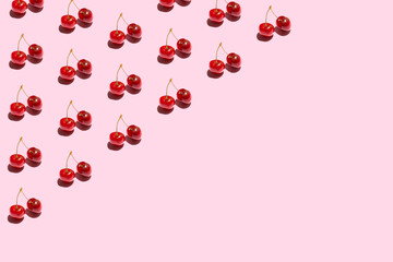 Seamless pattern with cherry. Tropical abstract background. Cherry on pastel pink background.