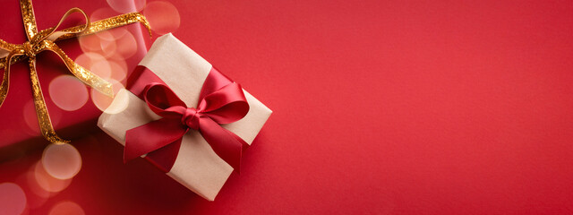 Red banner with two gift boxes and bokeh.