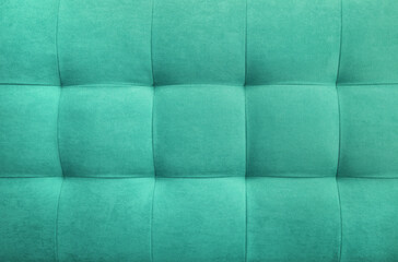 Turquoise suede leather background for the wall in the room. Interior design, headboards made of furniture fabric, furniture upholstery. Classic checkered pattern for furniture, wall, headboard
