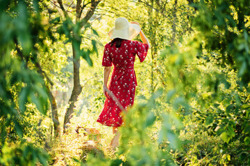 Woman in red dress enjoying nature. Nature therapy, ecotherapy, practice of being in nature to boost growth and healing, mental health. Connecting with nature benefits mental health.