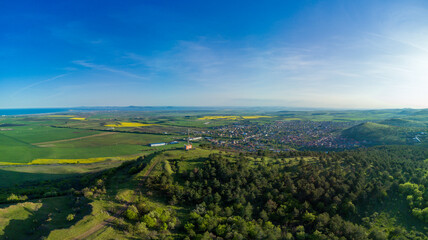 Panorama of the fields with a plant in a valley against the background of the village and the sky in Bulgaria