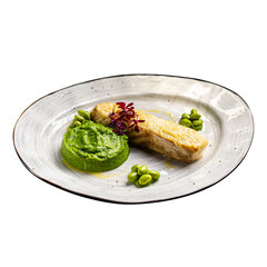 Isolated plate of grilled fish fillet with pea puree