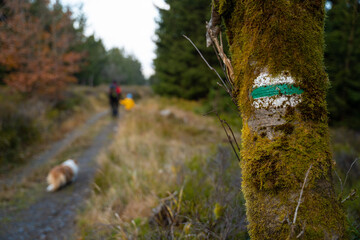 Tourist trail designation. People with a dog in the background