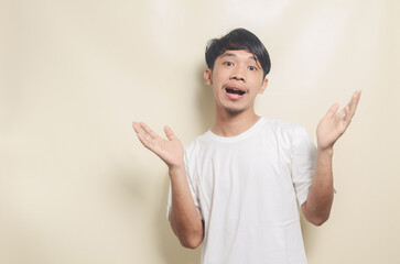 asian man wearing white t-shirt with surprised expression on isolated background