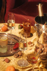 Valdobbiadene Prosecco flutes, a bottle, cocktails and fruit on a luxury colorful table. Prosecco is an italian sparkling wine cultivated and produced in Valdobbiadene-Conegliano area