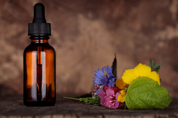 Mockup, bottle of essential oil with medicinal plants and flowers, aromatherapy, phytotherapy, wellness and spa natural extracts of essnetial oil. BACH therapy, remedy.