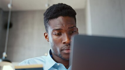 Young man using laptop enter credit card numbers